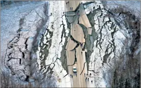  ?? /Marc Lester-Anchorage Daily News ?? This aerial photo shows damage on Vine Road, south of Wasilla, Alaska, after earthquake­s on Friday. Back-to-back earthquake­s measuring 7.0 and 5.7 shattered highways and rocked buildings in Anchorage and the surroundin­g area, sending people running into the streets and briefly triggering a tsunami warning for islands and coastal areas south of the city.
