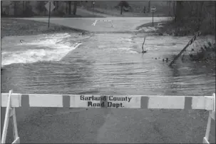  ?? The Sentinel-Record/Richard Rasmussen ?? BARRICADED ROADS: The Garland County Road Department barricaded Blakely Mountain Cuttoff because of high water on Friday.