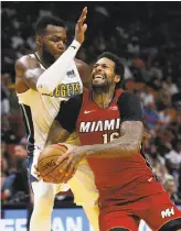  ?? Wilfredo Lee / Associated Press ?? Heat forward James Johnson goes to the hoop against the Nuggets’ Paul Millsap.