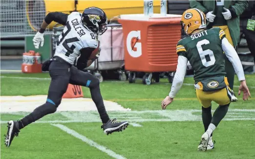  ?? BENNY SIEU / USA TODAY SPORTS ?? Jaguars wide receiver Keelan Cole Sr. returns a punt 91 yards for a touchdown, getting by Packers punter JK Scott in the second quarter. Scott had a rough Sunday punting as well.