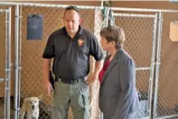  ?? STAFF PHOTO BY TYLER JETT ?? Whitfield County Animal Control Officer Shane Chastain, left, discusses his work Wednesday with County Commission Chairwoman Lynn Laughter at the animal shelter kennel.