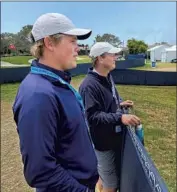  ?? Sam Farmer Los Angeles Times ?? JOE NEUHEISEL, left, and father Rick watch the activity at the Torrey Pines driving range Thursday.