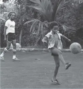  ?? (Photo: Adrian Boot) ?? Bob Marley and his son Ziggy playing football in the courtyard at their home, now the Bob Marley Museum at 56 Hope Road in St Andrew.