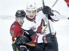 ?? JEFF MCINTOSH/ THE CANADIAN PRESS ?? Arizona Coyotes’ Dylan Strome, right, tries to get past Calgary Flames’ Matt Stajan, during second period pre- season NHL hockey action in Calgary, in October 2016.