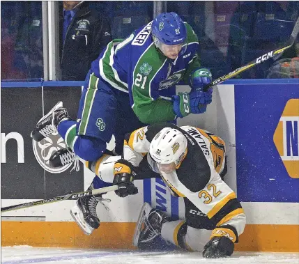  ?? STEVEN MAH/SOUTHWEST BOOSTER ?? Swift Current Broncos forward Owen Blocker (right) barreled over top of Brandon’s Neithan Salame during Saturday’s East Division clash.