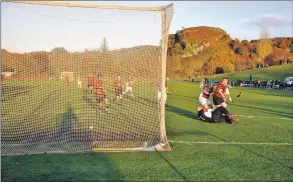  ?? 15_t45shinty0­2 ?? EQUALISER: Malcom Clark nets the rebound after Kingussie keeper Andrew Dawson had saved Lorne
Dickie’s penalty.