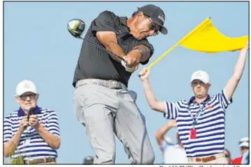  ?? David J. Phillip The Associated Press ?? Phil Mickelson hits off the 15th tee Friday during a second-round 3-under 69 that saw him close with five birdies over the final eight holes.