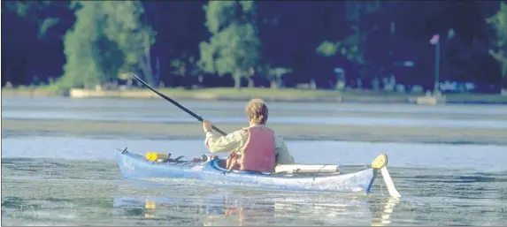  ?? PARKS ONTARIO ?? A woman kayaks on the Rideau River next to Rideau River Provincial Park near Ottawa. In summer, the water is warm, and it’s clean enough for swimming.