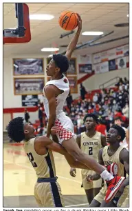  ?? (Special to the NWA Democrat-Gazette/Brian Sanderford) ?? Jacob Joe (middle) goes up for a dunk Friday over Little Rock Central’s Corey Camper (left) during the Grizzlies’ 70-66 victory over the Tigers at Kaundart Fieldhouse in Fort Smith.