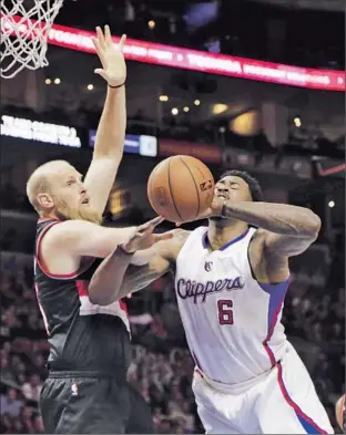  ?? Lawrence K. Ho Los Angeles Times ?? IT’S NOT UNUSUAL to see DeAndre Jordan getting fouled, this time by former teammate Chris Kaman. Jordan made only two of 10 free throws, but he grabbed 19 rebounds.