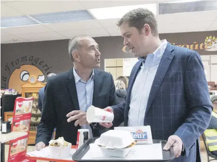  ?? JACQUES BOISSINOT/THE CANADIAN PRESS ?? Richard Martel, left, scored a convincing win Monday in the Chicoutimi-Le Fjord byelection, a boost for Andrew Scheer’s Conservati­ves in Quebec and a sign that for the first time since 1991 the next election in Quebec will be a two-party race.