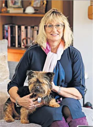  ??  ?? Clear mind: Jeanette Mclaughlin-barker, with her dog Furby, found the Alphastim gadget, right, eased her panic attacks and anxiety