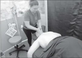  ?? Photo by Jessica Decker ?? Massage therapist Julie Olay performs a regular massage on a client.