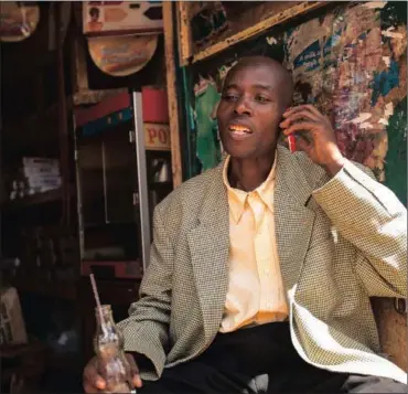 ?? PHOTO: BLOOMBERG ?? A resident speaks on a mobile phone in Nairobi, Kenya. In the six years since Kenya’s M-Pesa brought banking-by-phone to Africa, the service has grown from a novelty to a bona fide payment network.