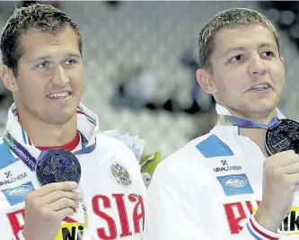  ?? POSTMEDIA NETWORK FILES ?? Russian swimmers Nikita Lobintsev, left, and Vladimir Morozov hold up their silver medals at the Swimming World Championsh­ips in Kazan, Russia, in this 2015 file photo. The pair — along with gold-medal winner Yuliya Efimova — have been barred from the...