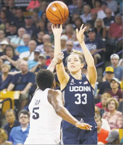  ?? Reinhold Matay / Associated Press ?? UConn’s Katie Lou Samuelson (33) shoots over Central Florida forward Masseny Kaba (5) on Sunday in Orlando, Fla.