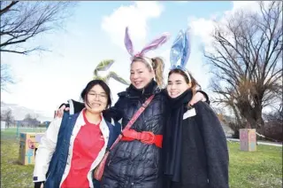  ?? STEVE MACNAULL/The Okanagan Weekend ?? Volunteers Haruka Sato, left, Amita McFarlane and Anny Weber donned bunny ears to help at the 15th annual Victory Life Fellowship Church Easter Egg Hunt & Pancake Breakfast on Friday at Kelowna’s Parkinson Recreation Centre.