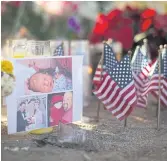  ??  ?? REMEMBERED: Photos of Robert Adams, a victim of the shootings, at a makeshift memorial.