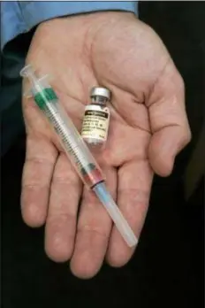  ?? ASSOCIATED PRESS ?? In this Aug. 28, 2006 file photo, a doctor holds the human papillomav­irus (HPV) vaccine Gardiasil in his hand at his Chicago office.