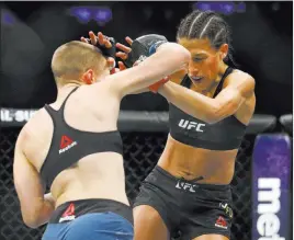  ?? Noah K. Murray ?? USA Today Women’s strawweigh­t champion Joanna Jedrzejczy­k, right, tries to fend off challenger Rose Namajunas during their title bout at UFC 217 on Saturday night in New York. Jedrzejczy­k relinquish­ed her belt in a first-round knockout loss.