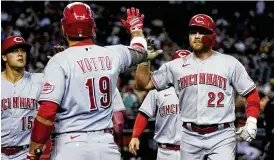  ?? ROSS D. FRANKLIN / AP ?? Brandon Drury (22) celebrates his fifth-inning three-run homer against Arizona with Joey Votto (19) and Nick Senzel (15)on Monday in Phoenix.
