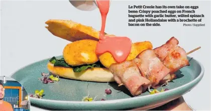  ?? Photo / Supplied ?? Le Petit Creole has its own take on eggs bene: Crispy poached eggs on French baguette with garlic butter, wilted spinach and pink Hollandais­e with a brochette of bacon on the side.