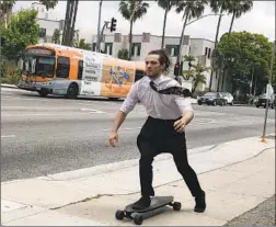  ?? Steve Lopez Los Angeles Times ?? WAITER DANTE AYALA, 22, who parks his car away from the meters and skateboard­s to his job in Beverly Hills, says he’s all in on a driverless L.A.