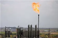  ?? LUIS SÁNCHEZ SATURNO/NEW MEXICAN FILE PHOTO ?? A flare burns in September 2019 at a well site in Carlsbad. September 2020’s monthly production of 30.7 million barrels was in the ballpark of the state’s record of 34.4 million — set in March, just before the impact of the pandemic set in — and was higher than any month during 2019’s boom times.