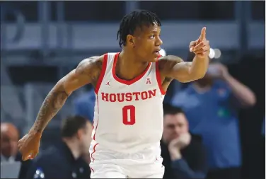  ?? Associated Press ?? Cougars pick up 30th win: Houston guard Marcus Sasser (0) reacts after scoring a 3-point basket against East Carolina during the second half of an NCAA college basketball game in the Ruartermna­ls of the American Athletic Conference Tournament Friday in Fort Worth, Texas. Houston won 60-46.