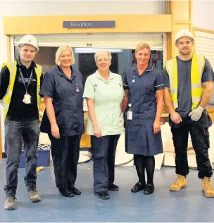  ??  ?? Chemothera­py unit staff sister Joanne Kippax, healthcare assistant Julie Carter and sister Angela Holden with constructi­on staff at the unit