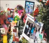  ?? RHONA WISE / AFP/Getty Images ?? Candles, flowers and stuffed animals serve as a memorial.