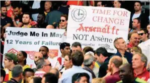  ??  ?? Arsenal fans hold up banners calling for a managerial change during Sunday’s Premier League football against Everton at the Emirates Stadium. – AFPPIX
legend Sir Alex Ferguson says Arsenal should hold onto Arsene Wenger if they can.
The Gunners...