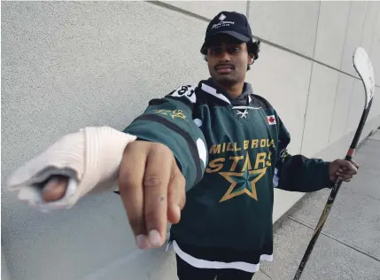  ?? CLIFFORD SKARSTEDT EXAMINER ?? Zachary Sukumaran, 17, shows his broken hand, which he suffered when he punched a dressing room door after being kicked out of a game for pushing an opponent who had taunted him with a racist comment. The other player didn’t get a penalty.