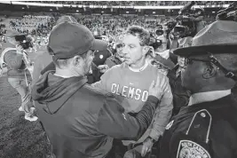  ?? SAM WOLFE Special To The State ?? South Carolina head coach Shane Beamer speaks with Clemson head coach Dabo Swinney following South Carolina’s game against Clemson at Williams-brice Stadium in Columbia on Nov. 25, 2023.