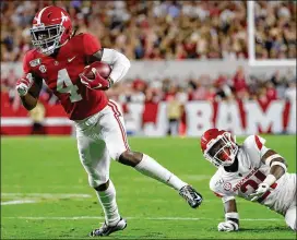  ?? KEVIN C. COX / GETTY IMAGES ?? Alabama’s Jerry Jeudy scores against Arkansas. The Crimson Tide’s schedule included no games against CFP-ranked opponents — until today.