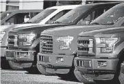  ?? [AP FILE PHOTO] ?? A row of 2015 Ford F-150 pickup trucks are parked on the sales lot at Butler County Ford in Butler, Pa. Ford is recalling about 2 million F-150 pickups in North America because the seat belts can cause fires.