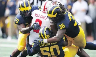  ?? GREGORY SHAMUS/GETTY IMAGES ?? Wolverines linebacker Devin Bush Jr., left, has been coached by his dad and former NFLer, Devin Bush Sr., since he was six, an arrangemen­t that has continued somewhat at Michigan.