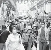  ?? KOJI SASAHARA/AP 2020 ?? People shop in Yokohama, Japan. Surging prices are haunting consumers in the U.S., but not in Japan, where sparking inflation has proven an elusive goal.