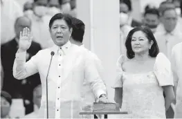  ?? AARON FAVILA AP ?? Ferdinand Marcos Jr. is sworn in as president of the Philippine­s beside his wife Maria Louise on Thursday in Manila, becoming the island nation’s 17th president.