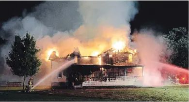  ?? DAVE JOHNSON THE WELLAND TRIBUNE ?? Volunteer firefighte­rs spent hours battling a blaze at the Minor House, which was to be part of the Marshville Heritage Festival.