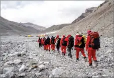  ?? SUN FEI / XINHUA ?? Members of the scientific expedition team make their way back to the Mount Qomolangma base camp on May 5.