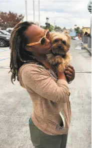  ?? Courtesy Melissa Smith ?? Oakland resident Melissa Smith reunites with Biscuit, her Yorkie who was missing for 10 days.