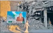  ?? AP ?? A campaign poster for parliament­ary elections is displayed near destroyed buildings from fighting in Mosul, Iraq.