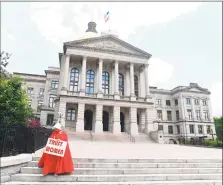  ?? Getty Images ?? An activist protests an Alabama bill that bans abortion under most circumstan­ces.
