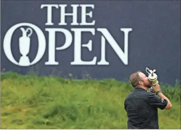  ?? Ap-peter Morrison, File ?? In this July 21, 2019 photo, Ireland’s Shane Lowry holds and kisses the Claret Jug trophy on the 18th green as he poses for the crowd and media after winning the British Open Golf Championsh­ips at Royal Portrush in Northern Ireland.
