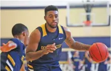  ?? STAFF PHOTO BY ERIN O. SMITH ?? UTC’s Jerry Johnson, shown dribbling the ball during the first day of basketball practice last month, has been impressed with the attitude of his freshman teammates.