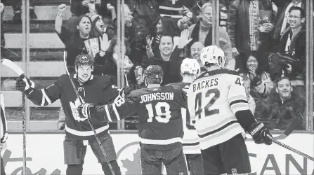  ?? STEVE RUSSELL TORONTO STAR ?? Auston Matthews, left, celebrates after winger Andreas Johnsson (18) scores against Boston on Saturday night.