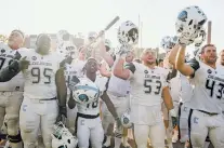  ?? JOHN TULLY/THE NEW YORK TIMES ?? The Columbia Lions sing the school fight song after a 22-17 win over Dartmouth on Saturday, bringing the team to 6-0, in Hanover, N.H. A number of Columbia alumni are perversely proud of the school’s long tradition of dismal football results and not...