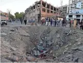  ?? WAKIL KOHSAR, AFP/GETTY IMAGES ?? The tanker truck bomb was so powerful it left a crater in the concrete and gutted an entire city block. More than 400 people were wounded in the blast.