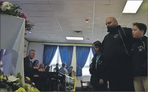  ?? GREG MCNEIL/CAPE BRETON POST ?? The laying of flowers and the roll call of memorial flowers are part of each annual Day of Mourning ceremony. Hunter, Marc and Colton Chisholm are shown representi­ng the NSGEU at ceremonies in Whitney Pier on Friday.